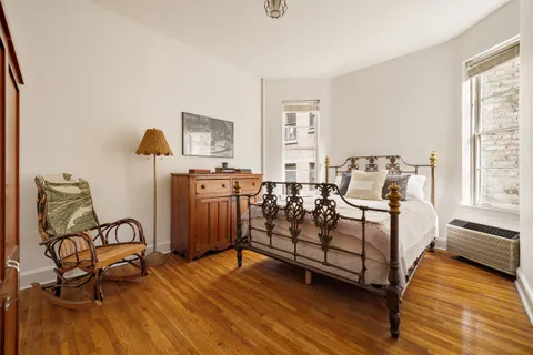 a bedroom with furniture and wooden floor
