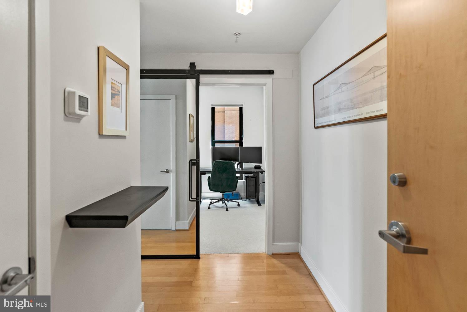 910 M Street Northwest, Unit 403 Washington, DC 20001 - Photo 16 of 31 a hallway with a door and stairs