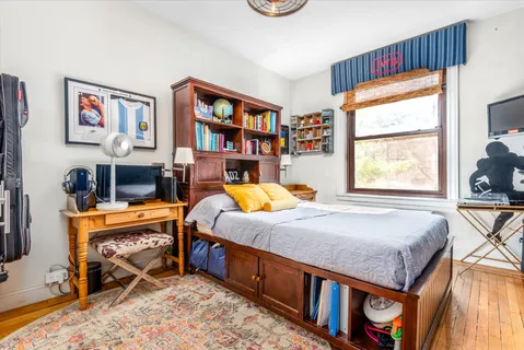 a bed room with a bed and a window