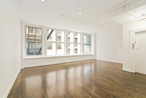 6 Murray Street, Unit 2 Manhattan, NY 10007 - Photo 2 of 7 a view of an empty room with wooden floor and a window