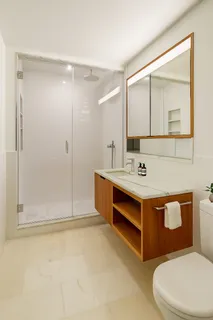 a bathroom with a sink mirror vanity and toilet