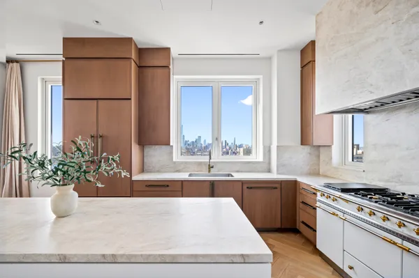 a kitchen with stainless steel appliances kitchen island wooden cabinets and stove