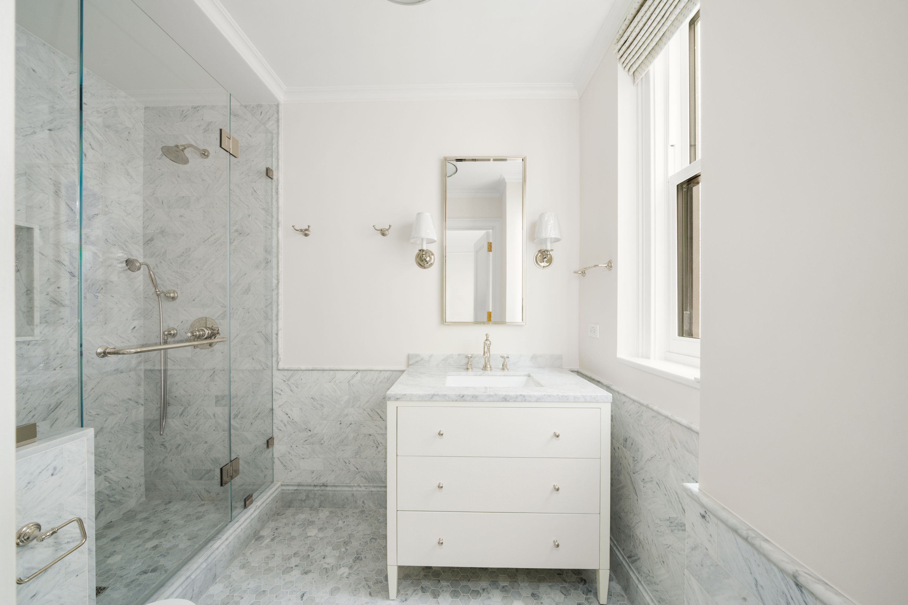 108 East 82nd Street, Unit 7C Manhattan, NY 10028 - Photo 5 of 9 a bathroom with a sink shower and a mirror