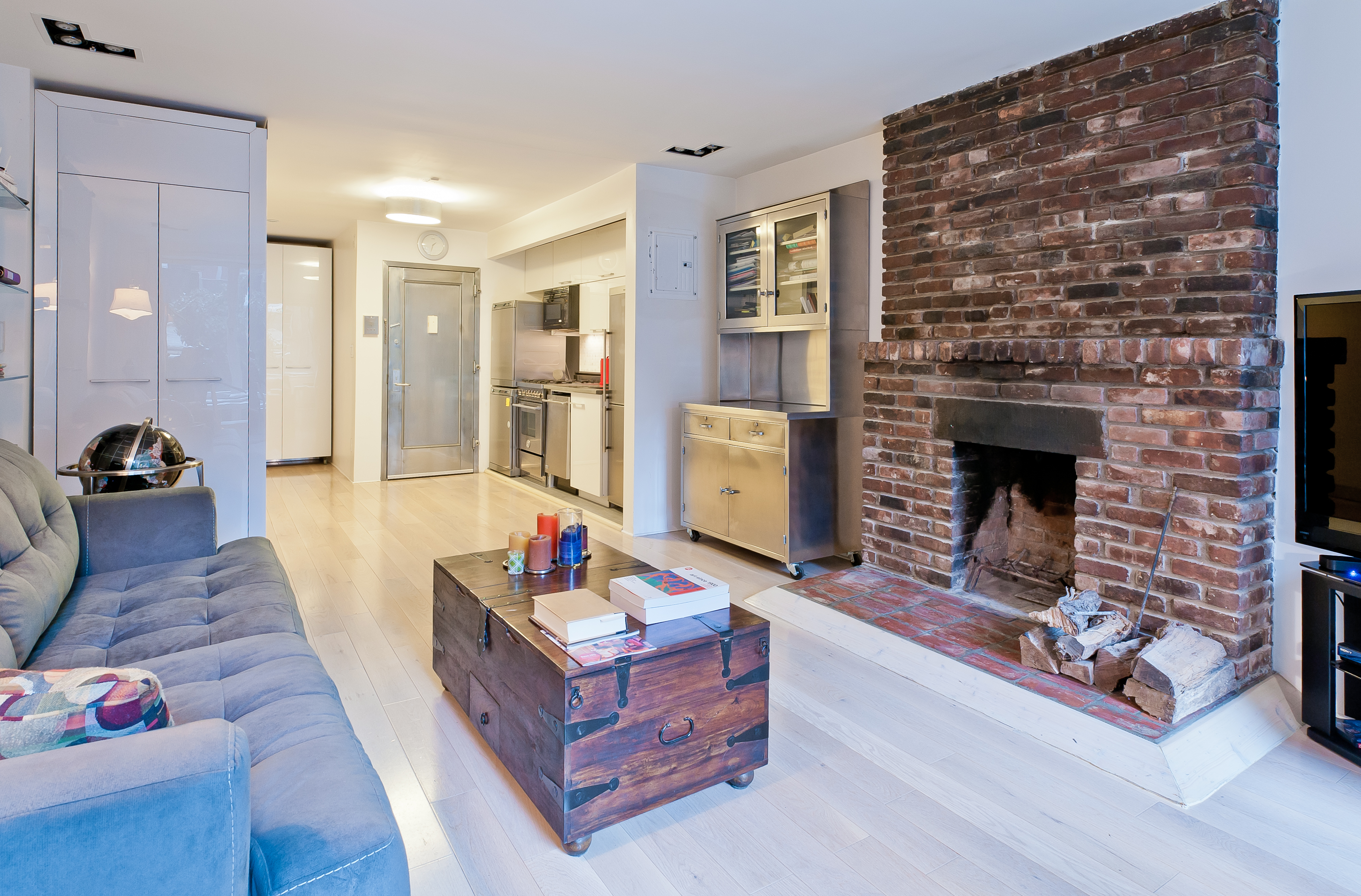 10 Charles Street, Unit 2B Manhattan, NY 10014 - Photo 5 of 8 a living room with furniture and a fireplace