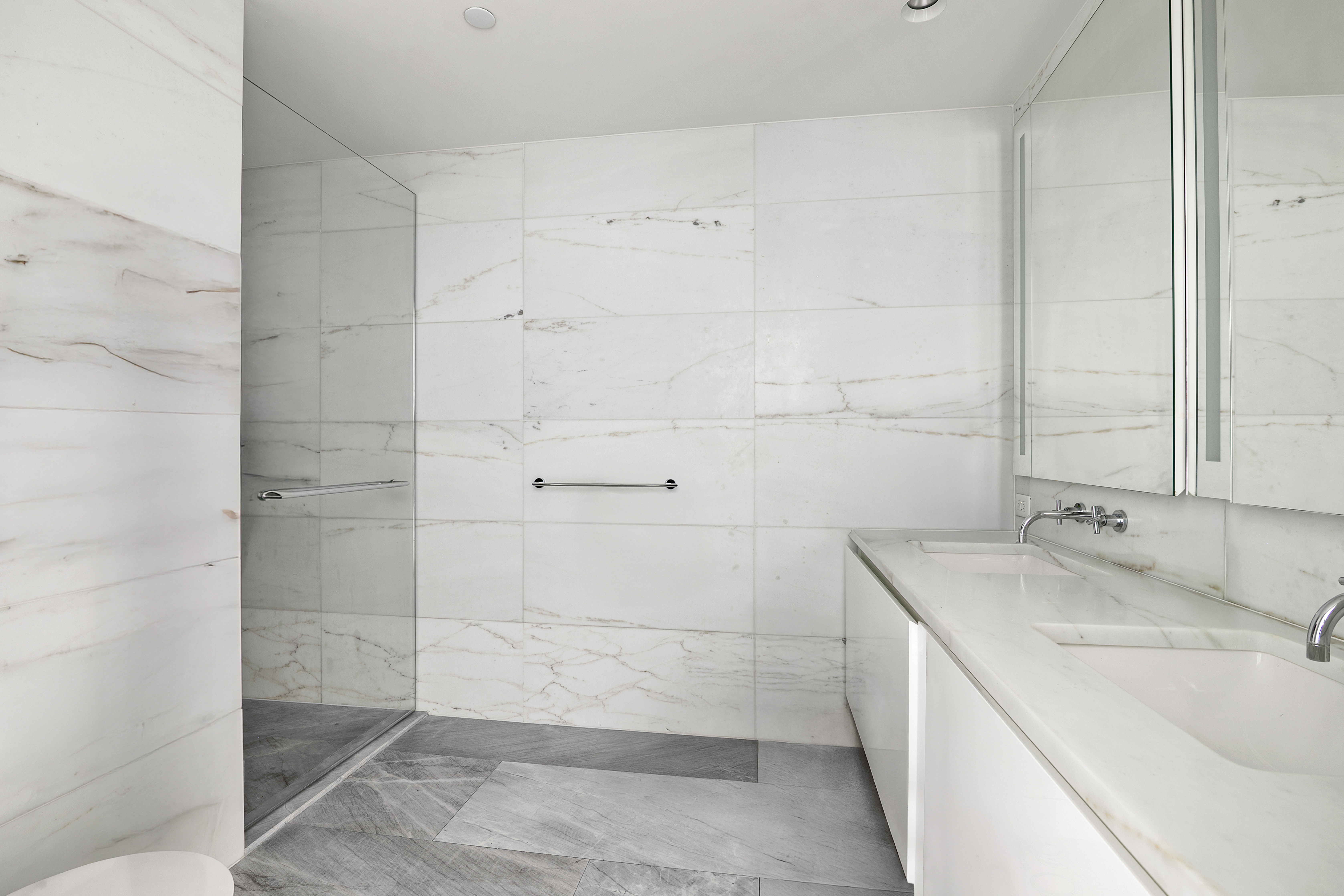 695 1st Avenue, Unit 33B Manhattan, NY 10016 - Photo 7 of 25 a bathroom with a sink and shower