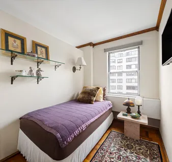 a bedroom with a bed couch and a window
