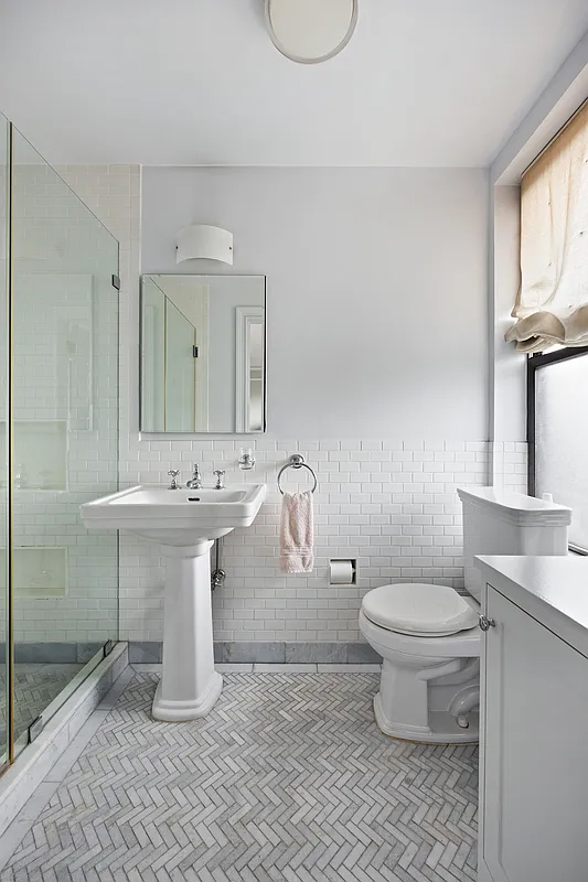 415 Central Park West, Unit 6A Manhattan, NY 10025 - Photo 17 of 25 a bathroom with a sink toilet and a mirror