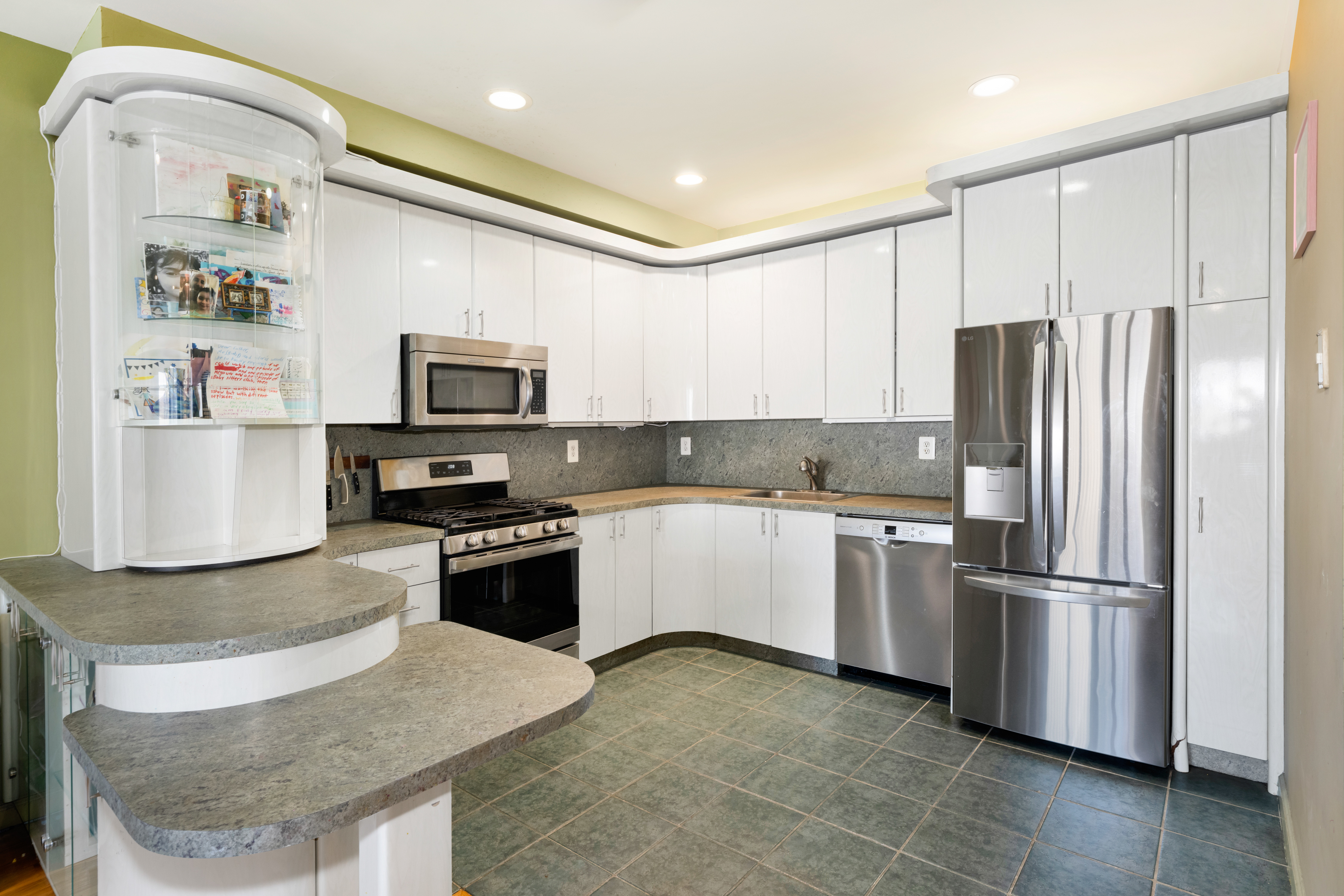 2356 61st Street, Unit 1B Brooklyn, NY 11204 - Photo 3 of 10 a kitchen with granite countertop stainless steel appliances and refrigerator