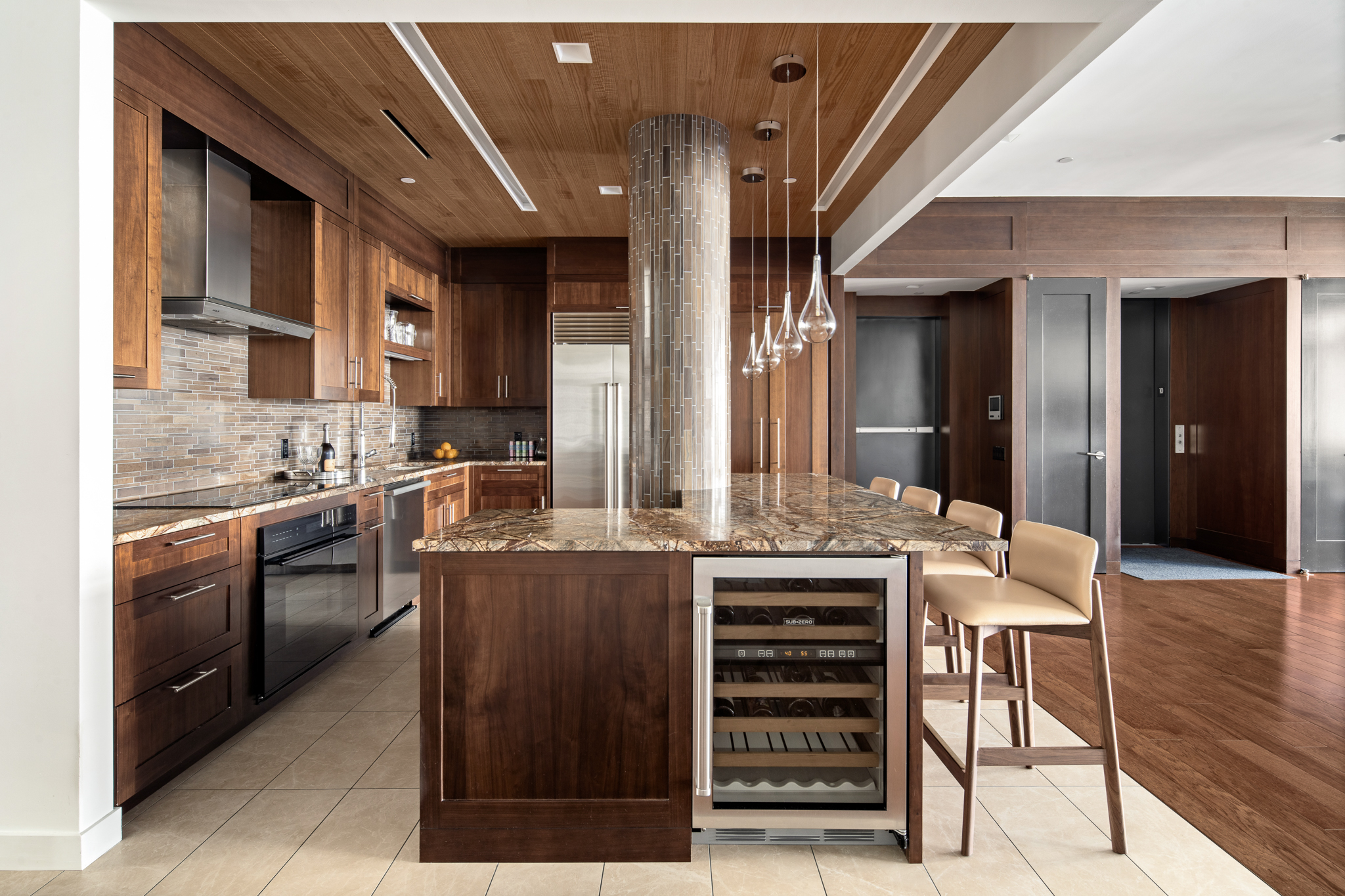561 Broadway, Unit 10C Manhattan, NY 10012 - Photo 6 of 11 a kitchen with stainless steel appliances kitchen island granite countertop a stove and cabinets