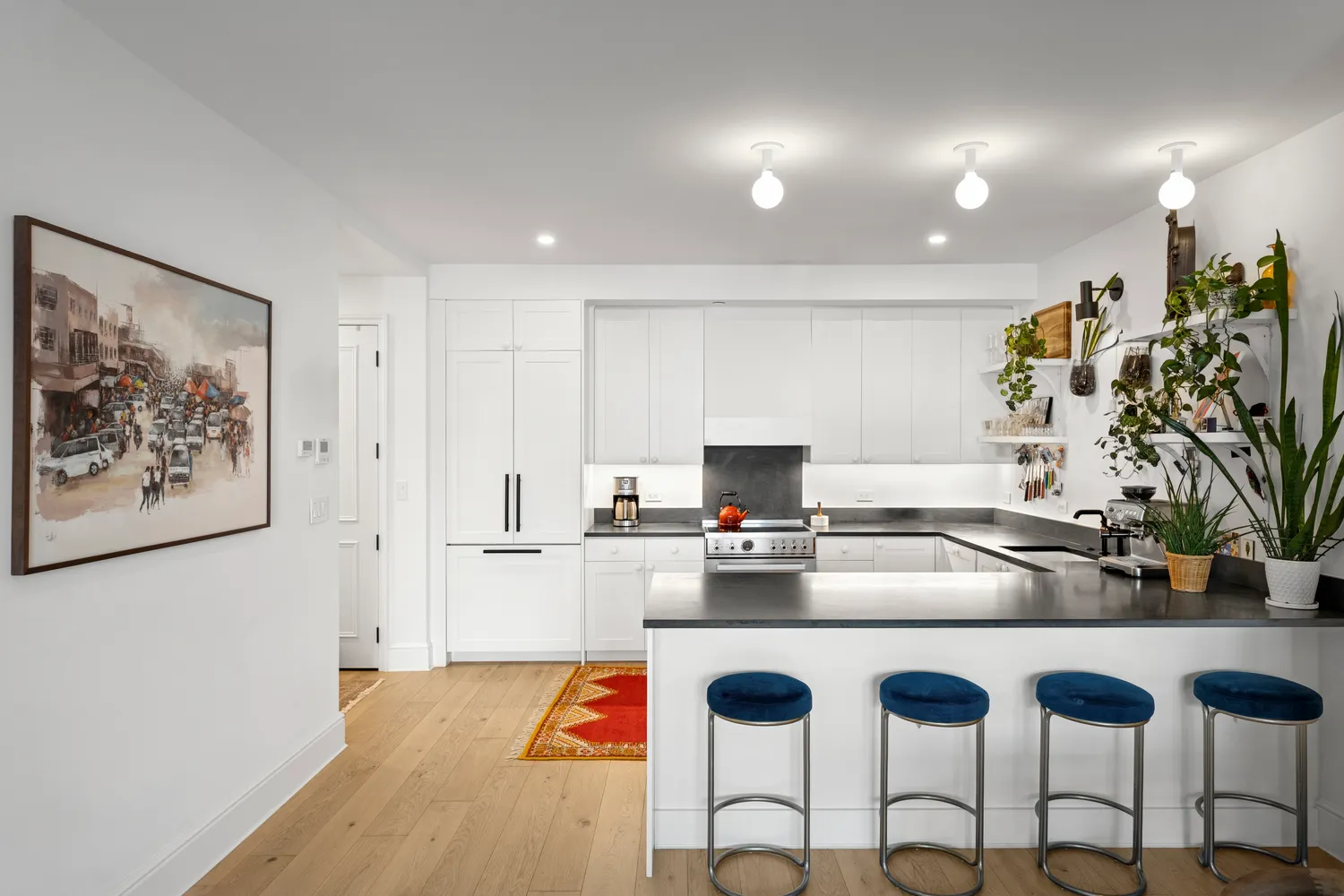 a kitchen with granite countertop a refrigerator and a stove