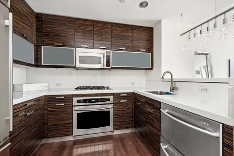 a kitchen with stainless steel appliances granite countertop a stove and a sink