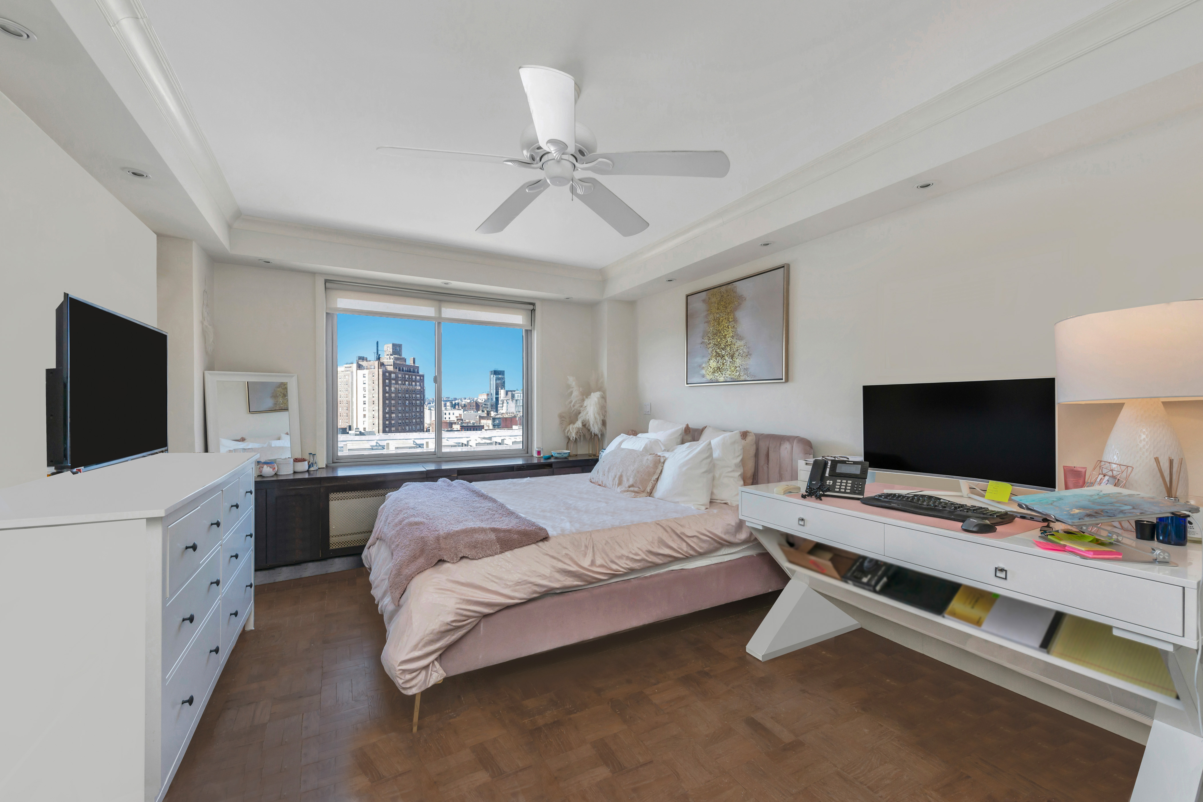 175 West 12th Street, Unit 12F Manhattan, NY 10011 - Photo 6 of 10 a bedroom with a bed and a flat screen tv