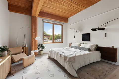 a bedroom with bed couch and window