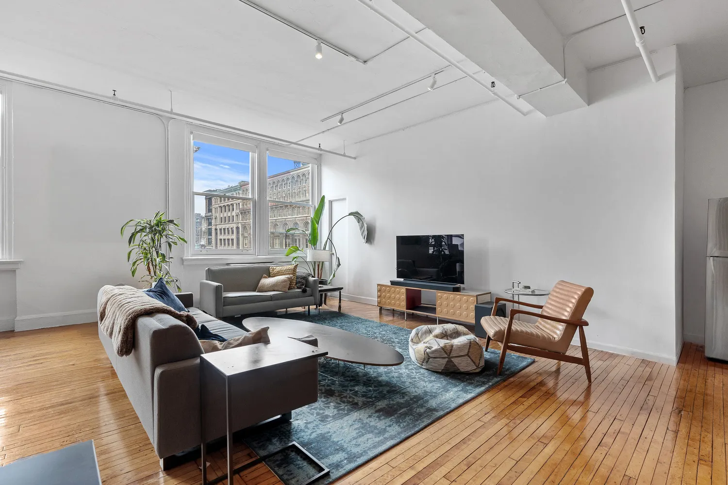 a living room with furniture and a flat screen tv