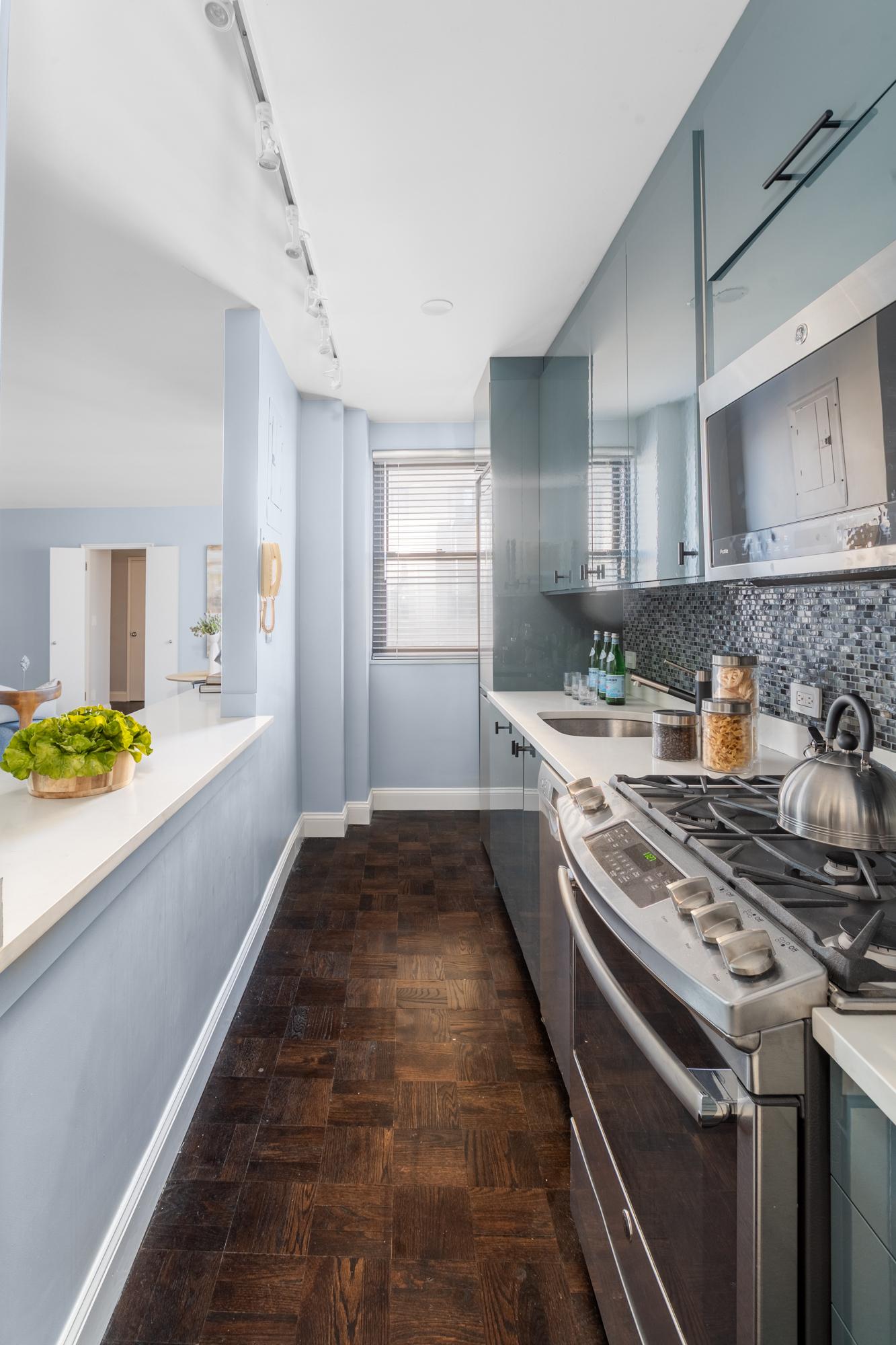 315 East 72nd Street, Unit 16A Manhattan, NY 10021 - Photo 6 of 12 a kitchen with a stove and a sink