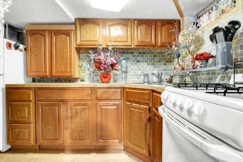 a kitchen with stainless steel appliances granite countertop a sink and a refrigerator