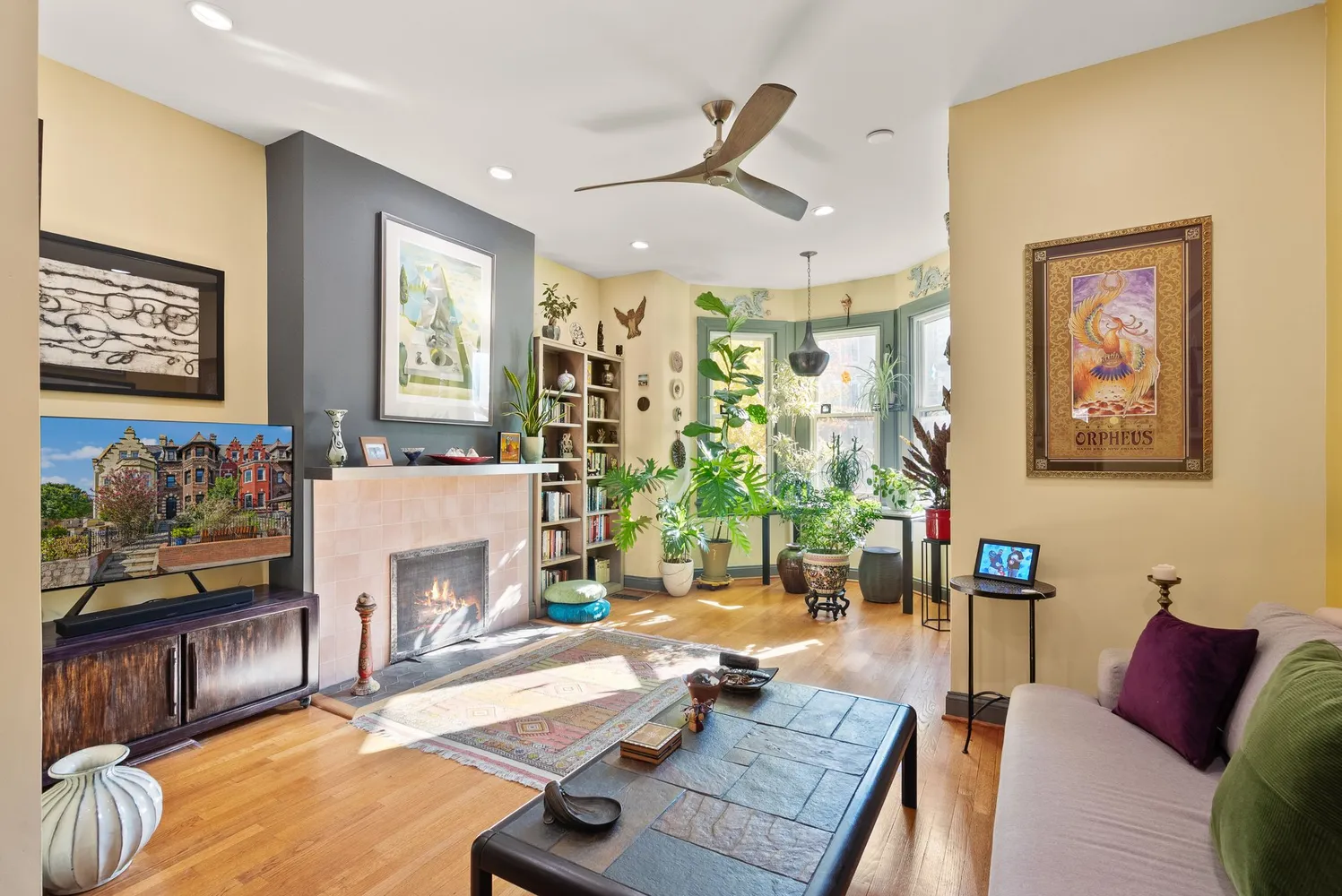 a living room with furniture a rug and a wall painting