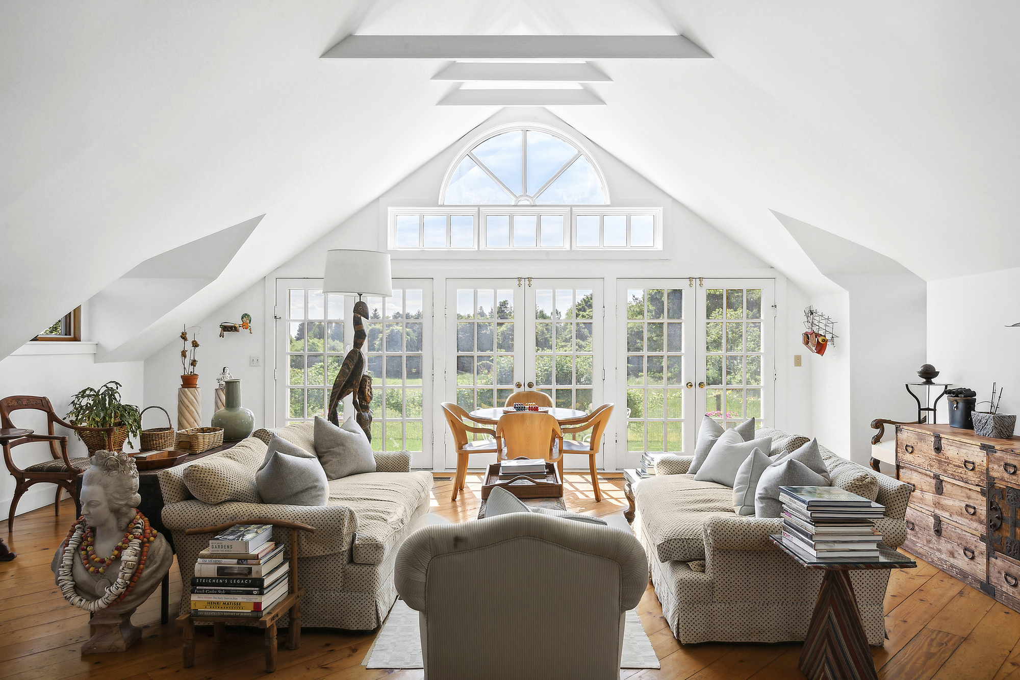 488 Ocean Road Bridgehampton, NY 11932 - Photo 4 of 21 a living room with furniture a large window and a chandelier