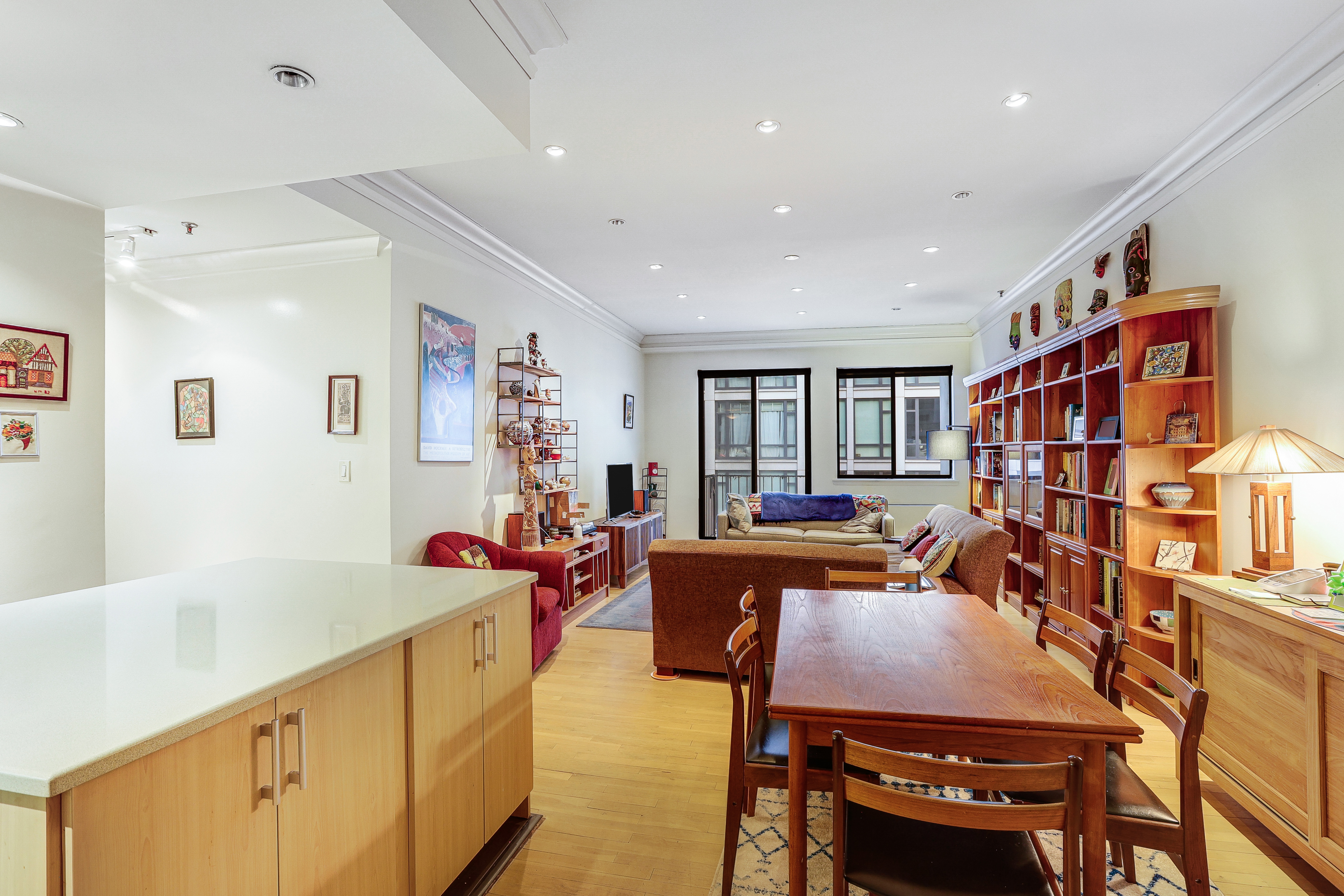 a living room with furniture a couch and a bookshelf