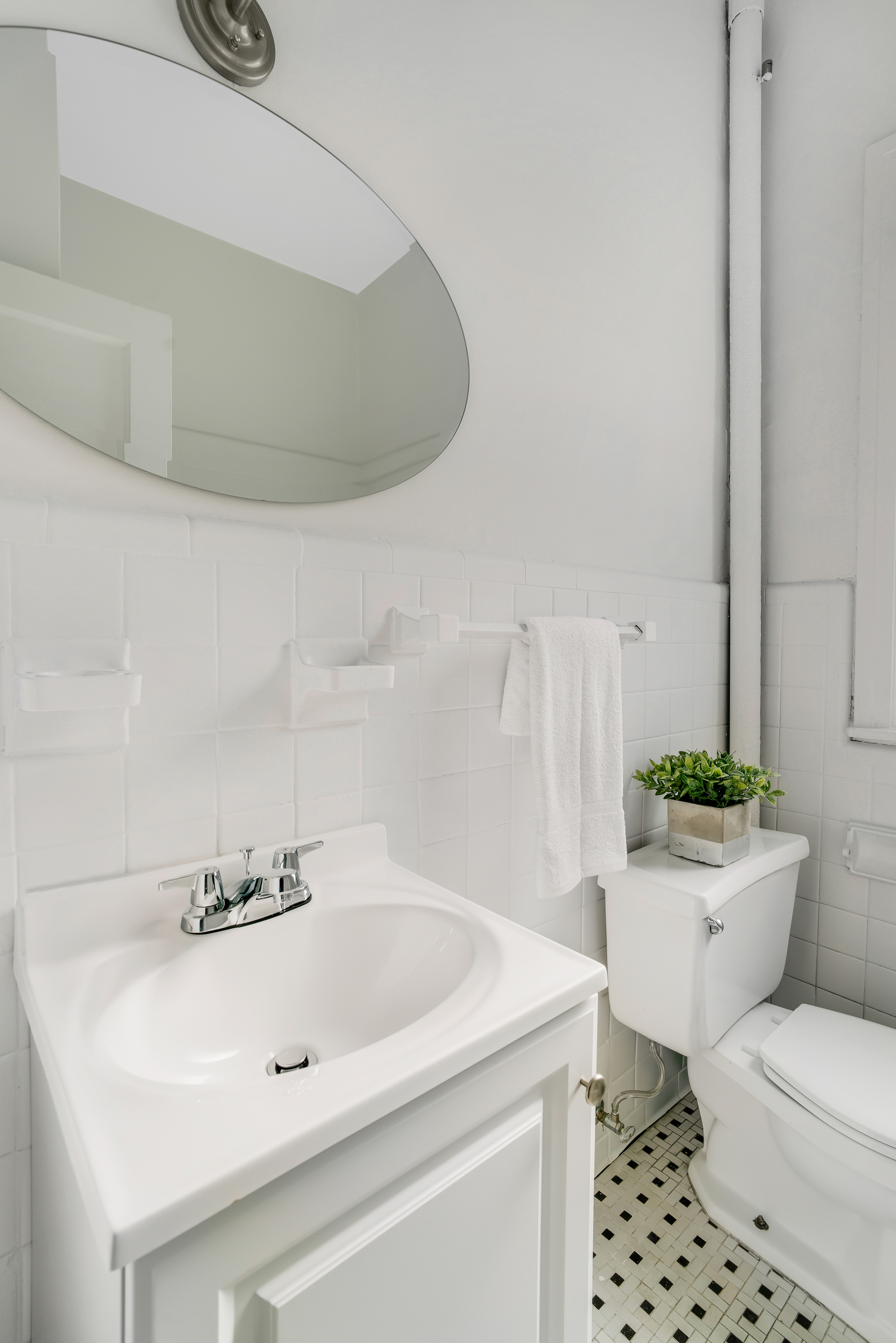 1349 Lexington Avenue, Unit PH2 Manhattan, NY 10128 - Photo 11 of 18 a bathroom with a sink a toilet and a mirror
