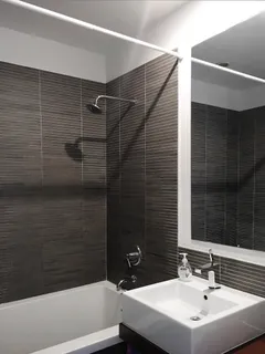 a bathroom with a sink a mirror and shower