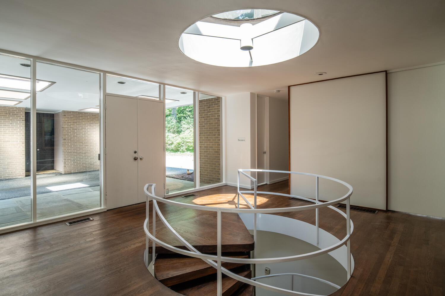 7101 Crail Drive Bethesda, MD 20817 - Photo 4 of 15 a dining room with wooden floor a glass table and chairs