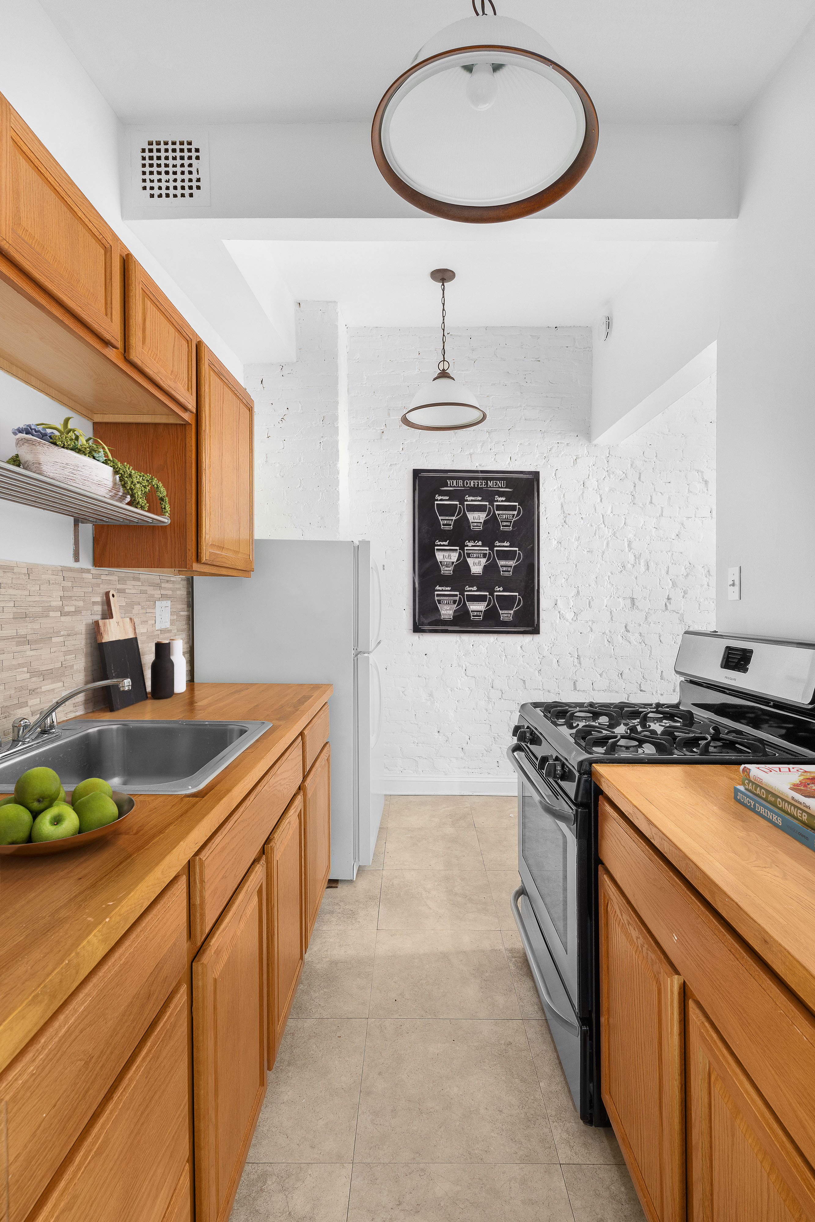 168 Dean Street, Unit 2 Brooklyn, NY 11217 - Photo 2 of 7 a kitchen with stainless steel appliances a stove a sink and a refrigerator