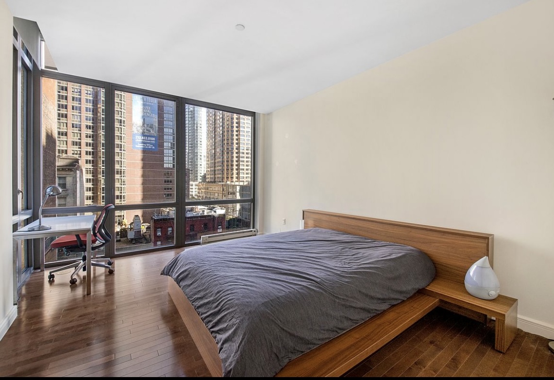 101 West 24th Street, Unit 7A Manhattan, NY 10011 - Photo 7 of 13 a spacious bedroom with a bed and glass windows