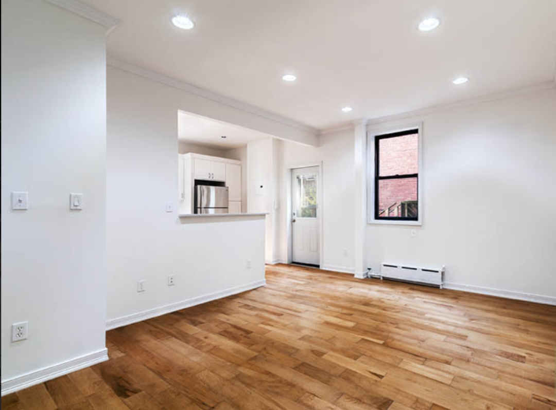 573 6th Street, Unit 3 Brooklyn, NY 11215 - Photo 2 of 19 an empty room with wooden floor and windows
