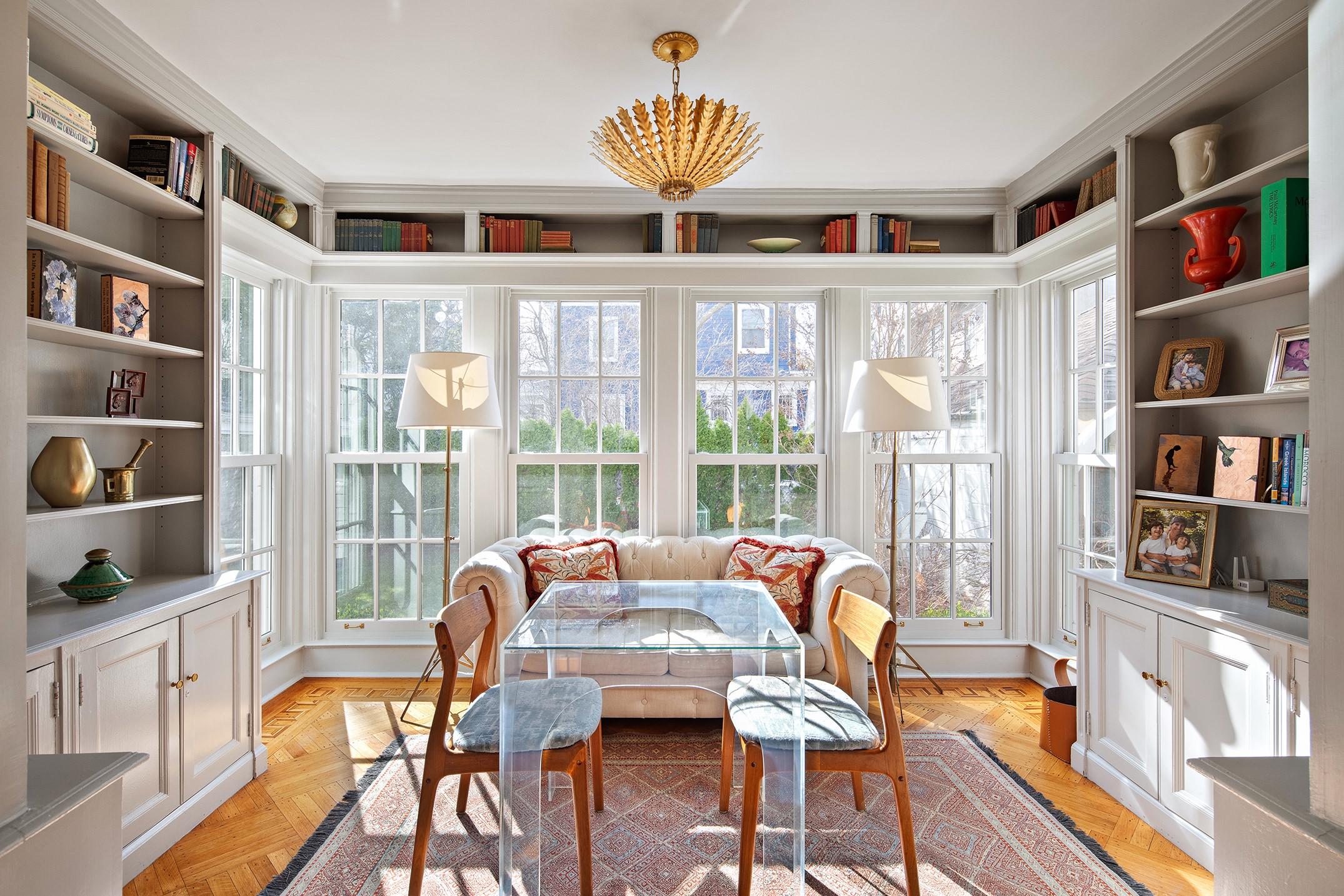 a living room with furniture and a book shelf