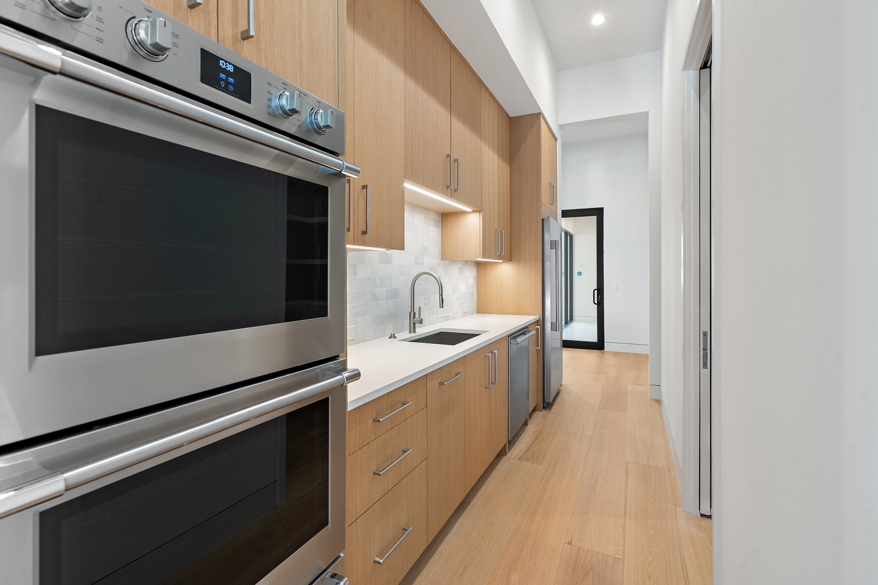 1905 Hallam Drive Austin, TX 78746 - Photo 13 of 39 a kitchen with stainless steel appliances a stove microwave and cabinets