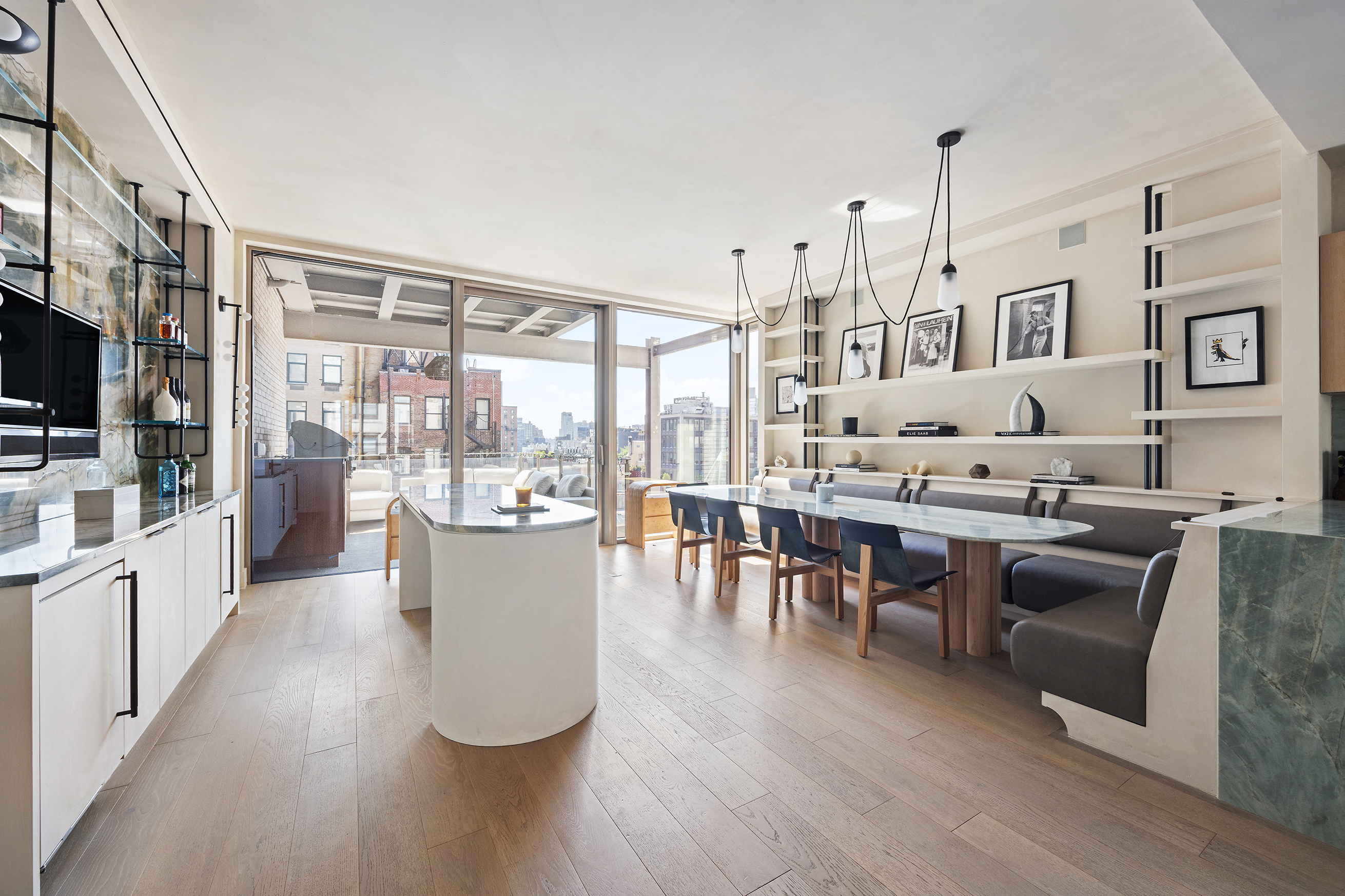 1 Great Jones Alley, Unit 10 Manhattan, NY 10012 - Photo 5 of 41 a living room with couches a flat screen tv and kitchen view
