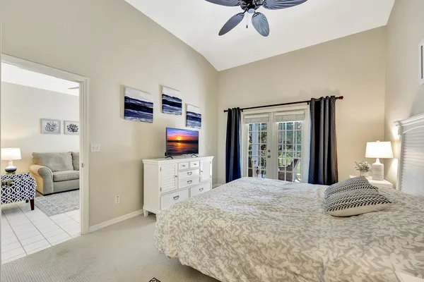 a bedroom with a large bed and a flat tv screen