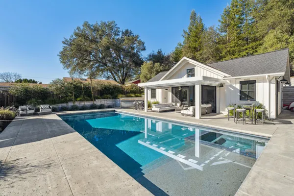 a kitchen with a table chairs stove and cabinets