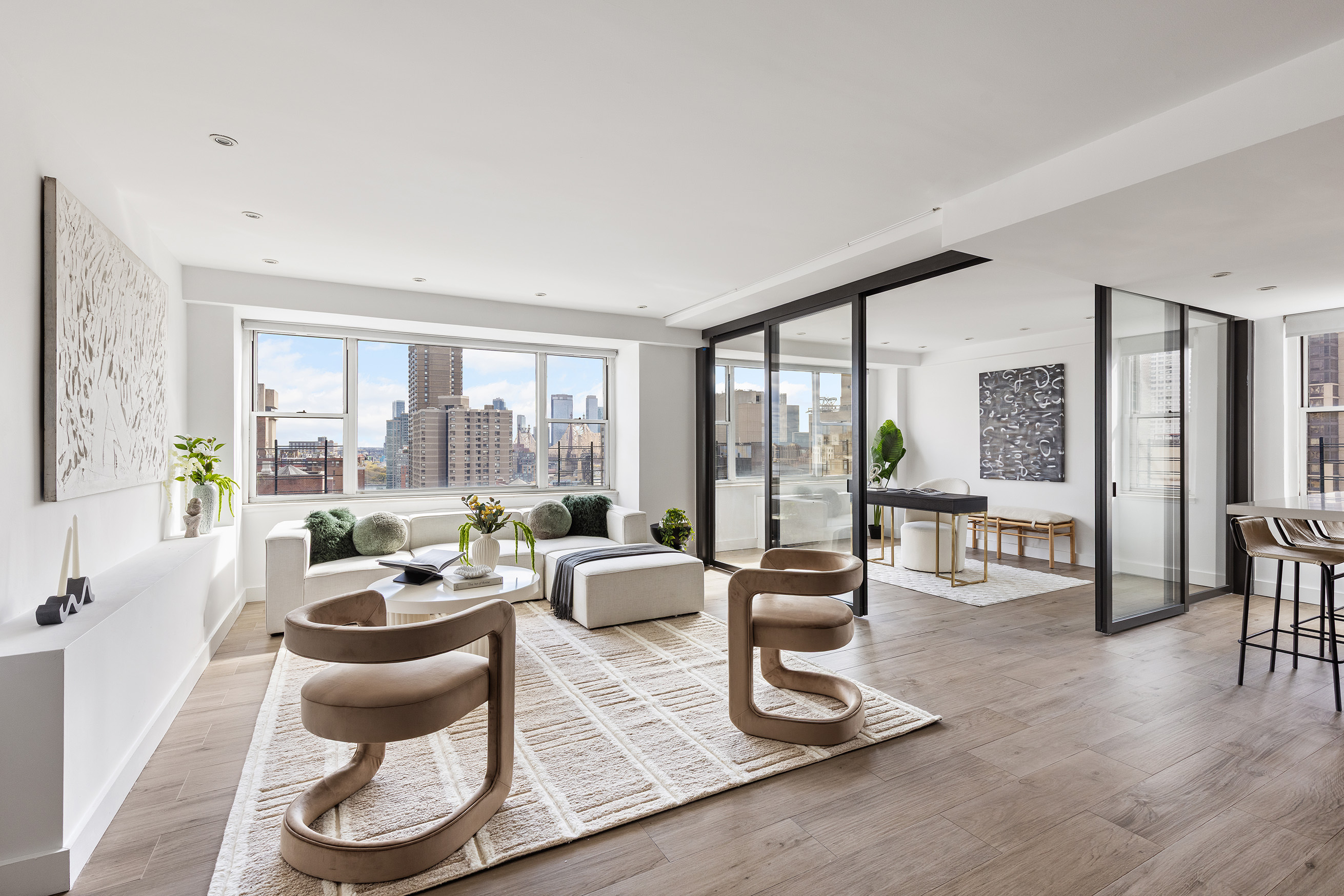 a living room with furniture and floor to ceiling windows