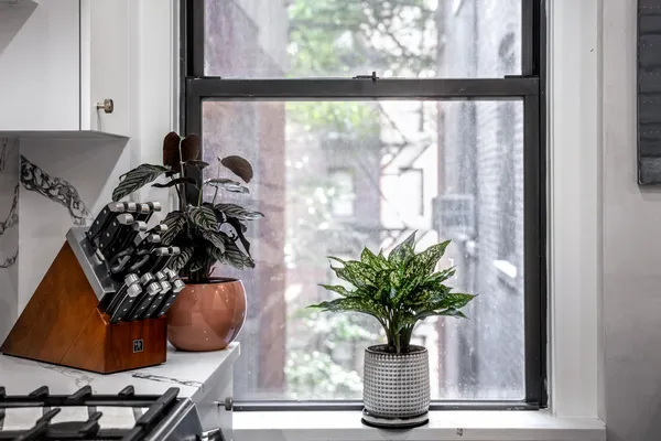 a view of a vase of flowers sitting on a table with window