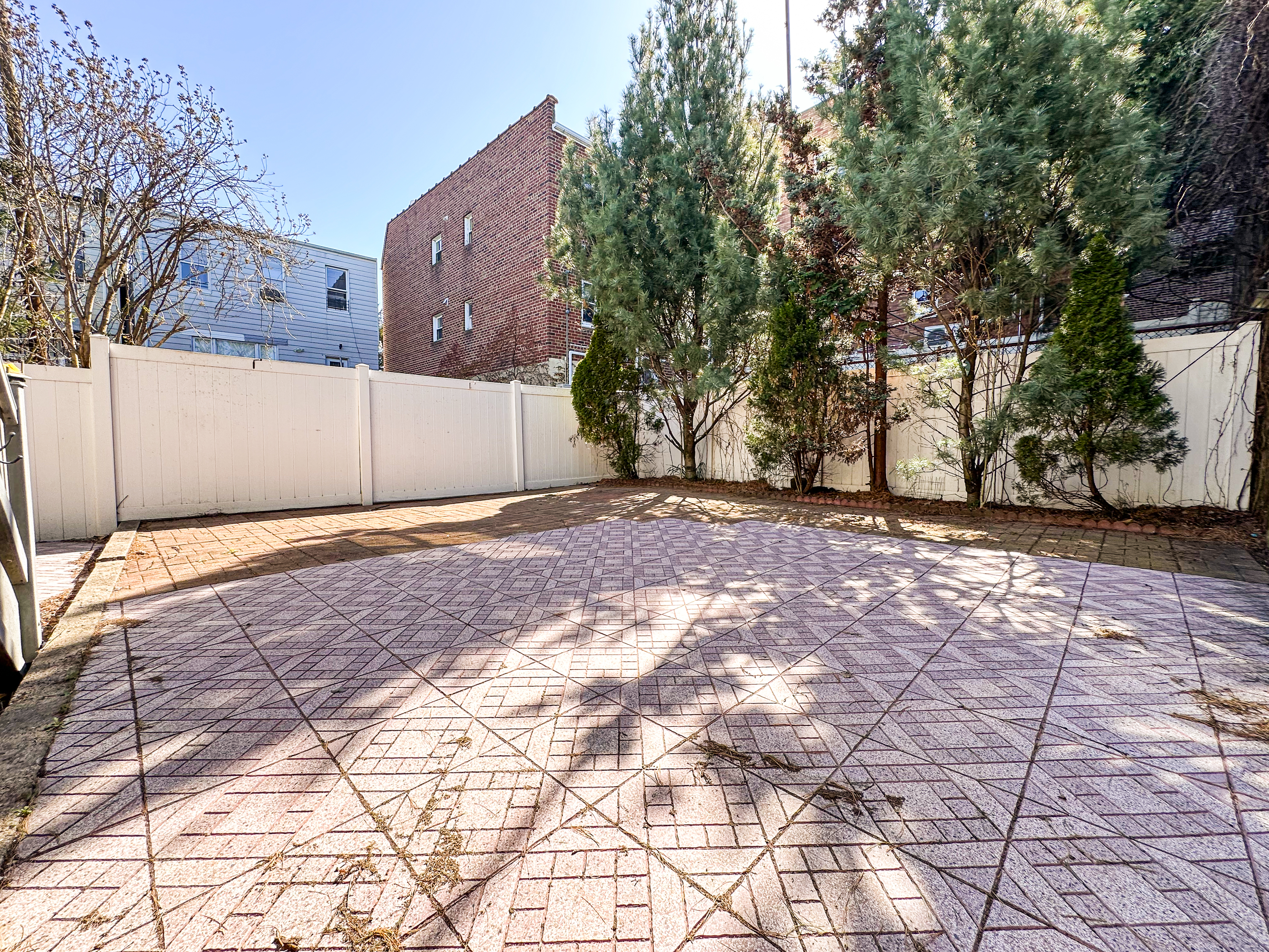 66-42 Clinton Avenue, Unit 2 Queens, NY 11378 - Photo 5 of 14 a view of a yard with large trees