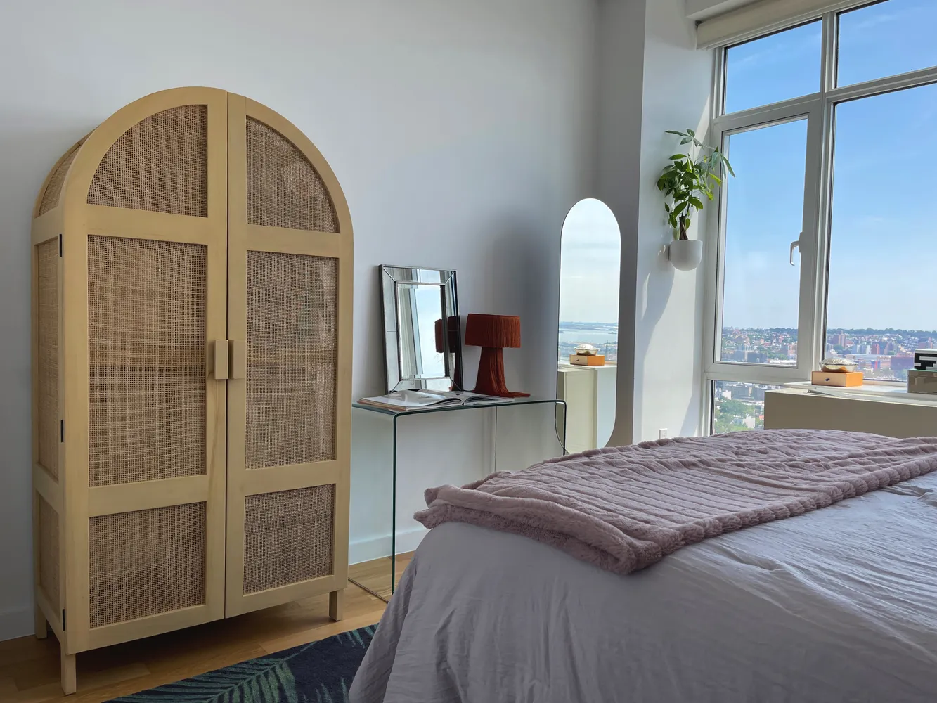 a bedroom with a bed and a mirror