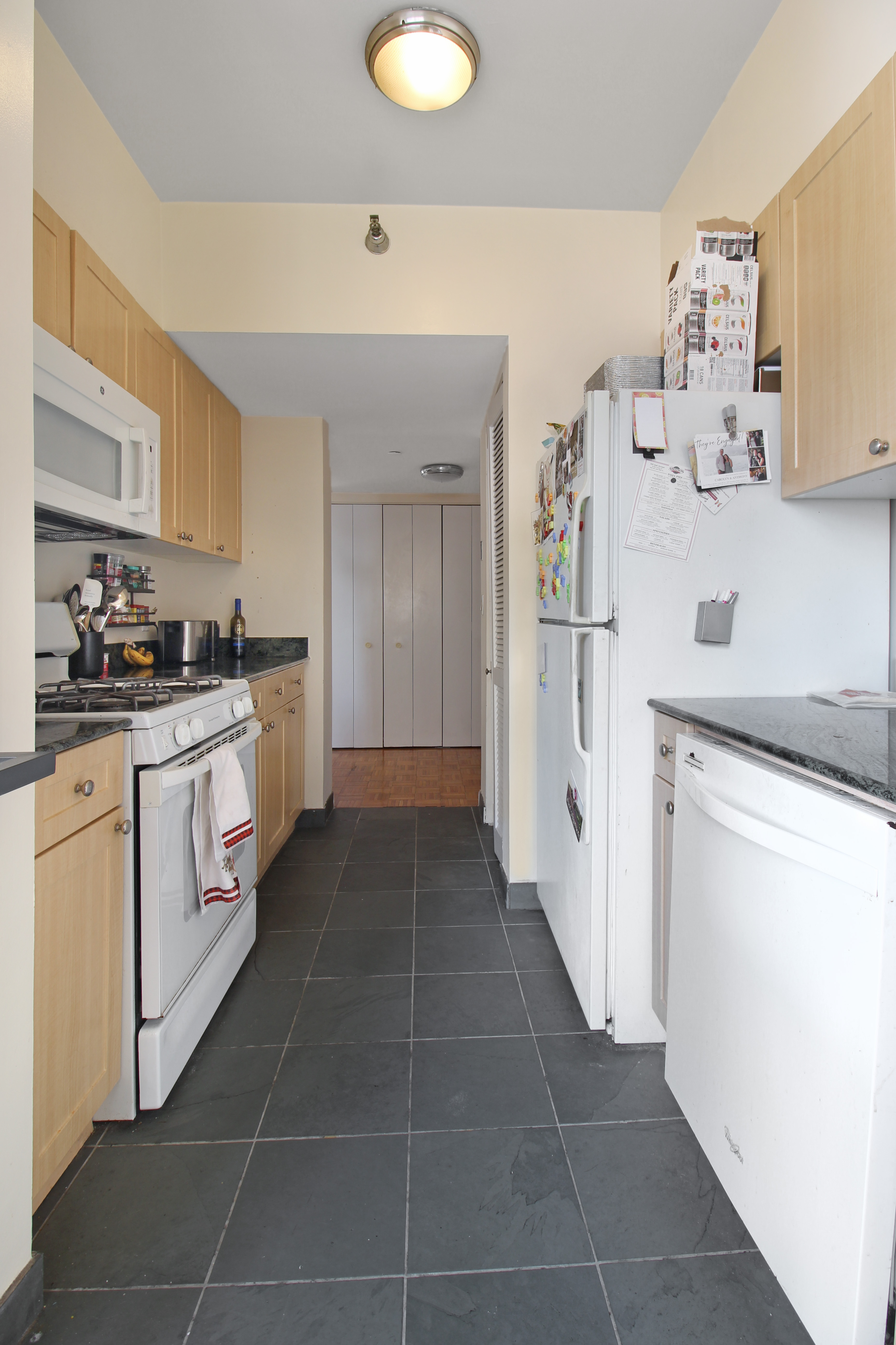 308 East 38th Street, Unit 20A Manhattan, NY 10016 - Photo 3 of 13 a kitchen with a cabinets and white appliances