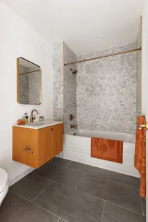 a bathroom with a tub a sink and a shower