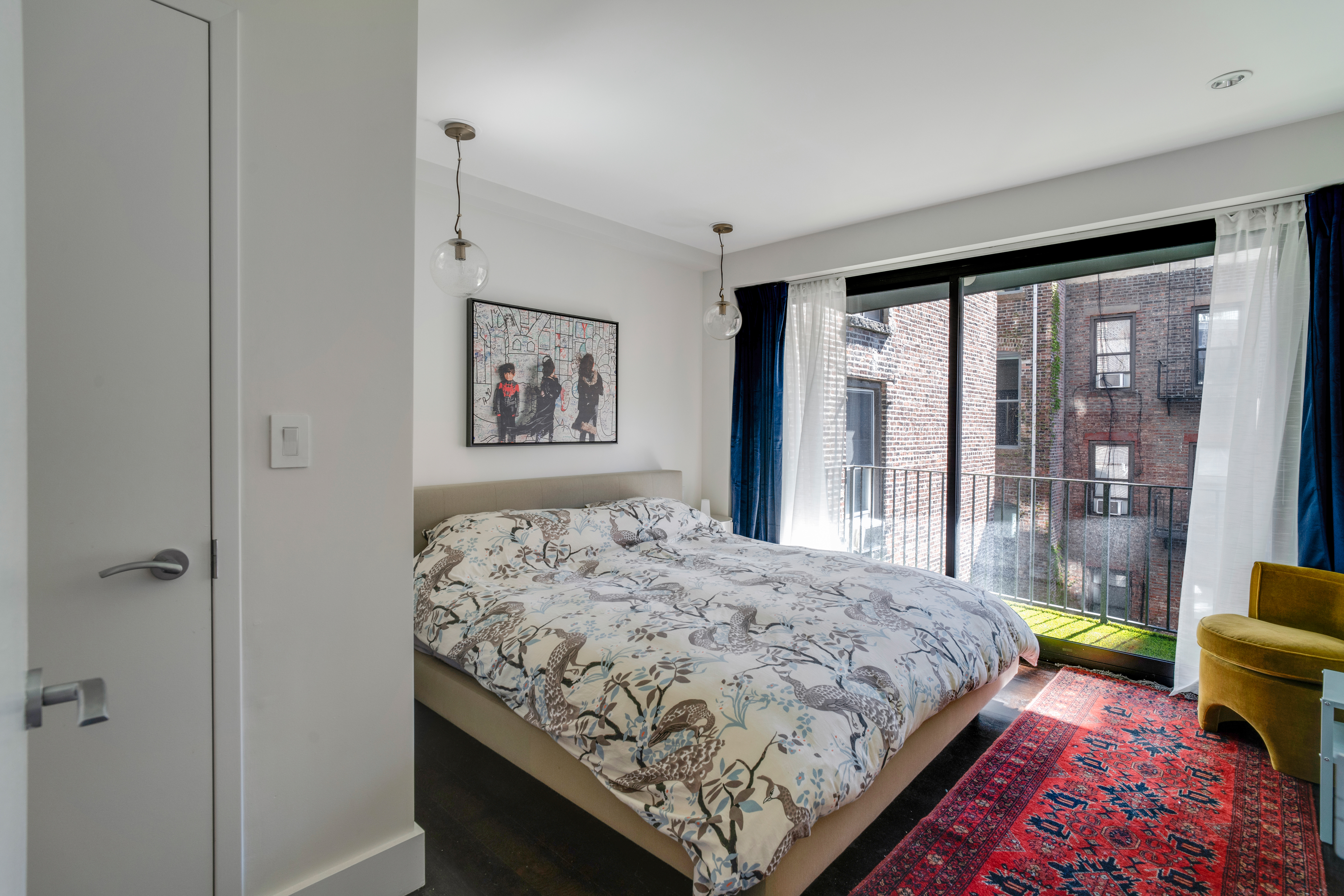 60 Orchard Street, Unit 4 Manhattan, NY 10002 - Photo 9 of 18 a bedroom with a bed painting and a large window