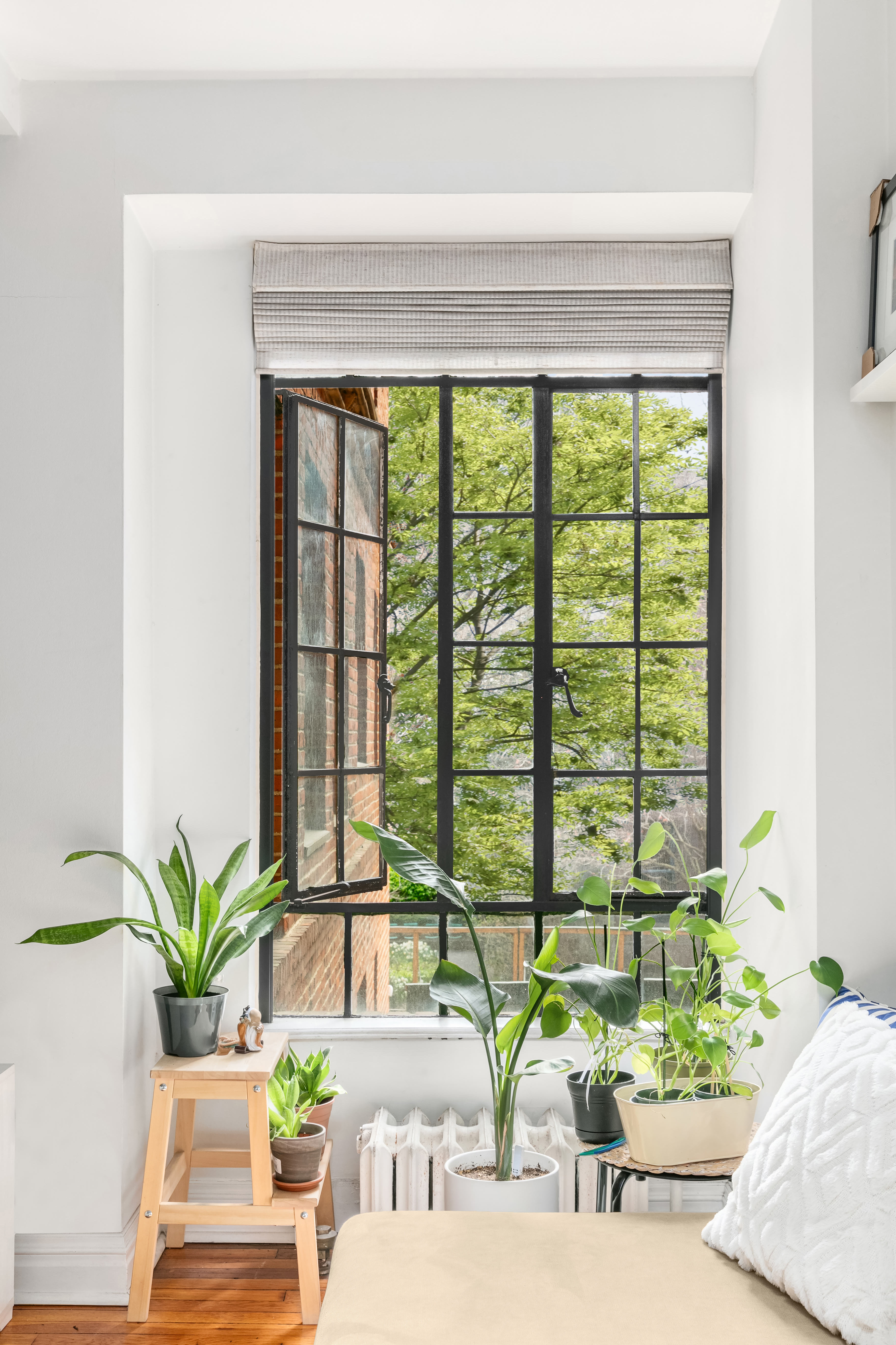 333 East 43rd Street, Unit 311 Manhattan, NY 10017 - Photo 3 of 18 a living room with furniture and large windows