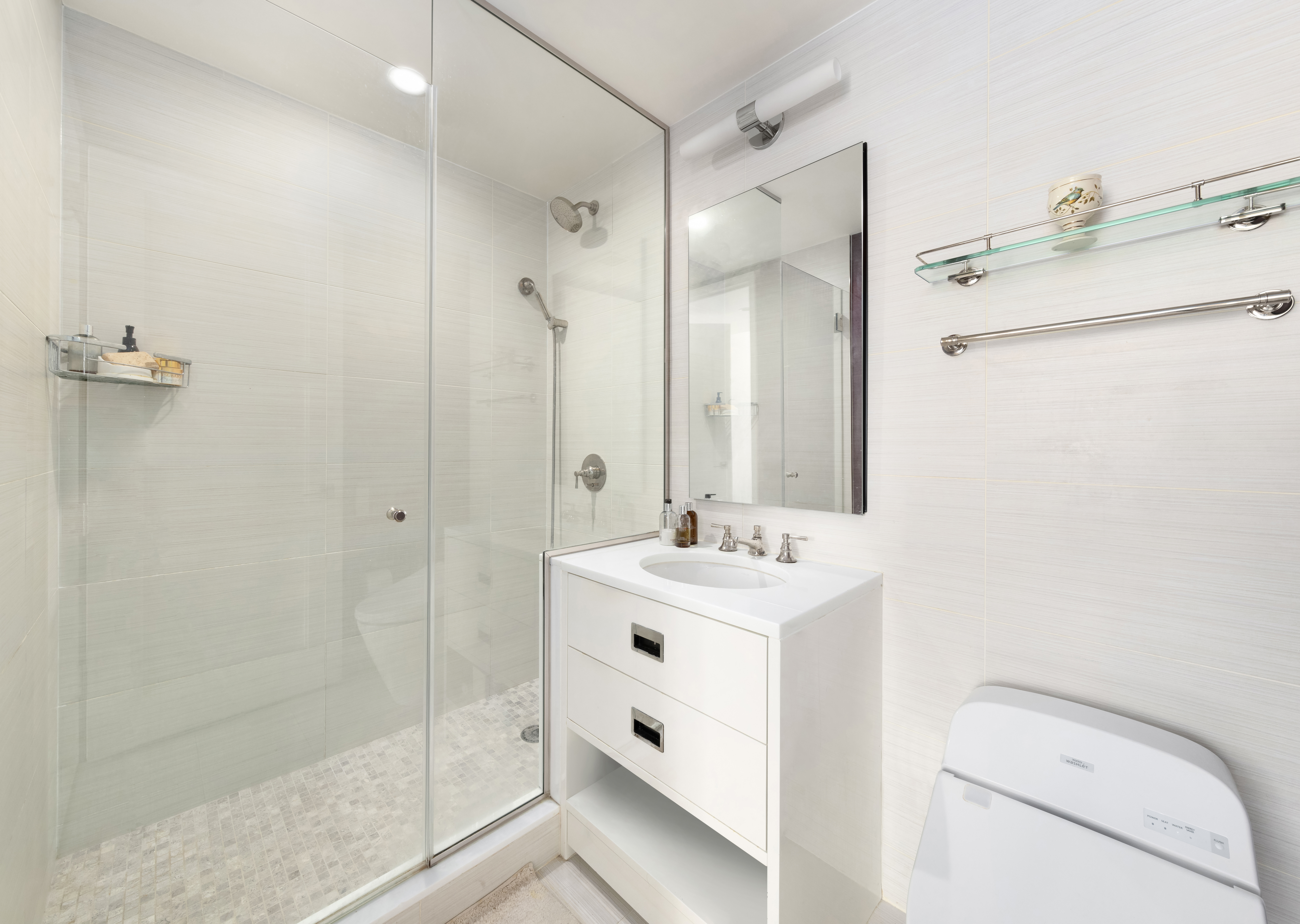 305 East 85th Street, Unit 14D Manhattan, NY 10028 - Photo 10 of 11 a bathroom with a sink a toilet and shower