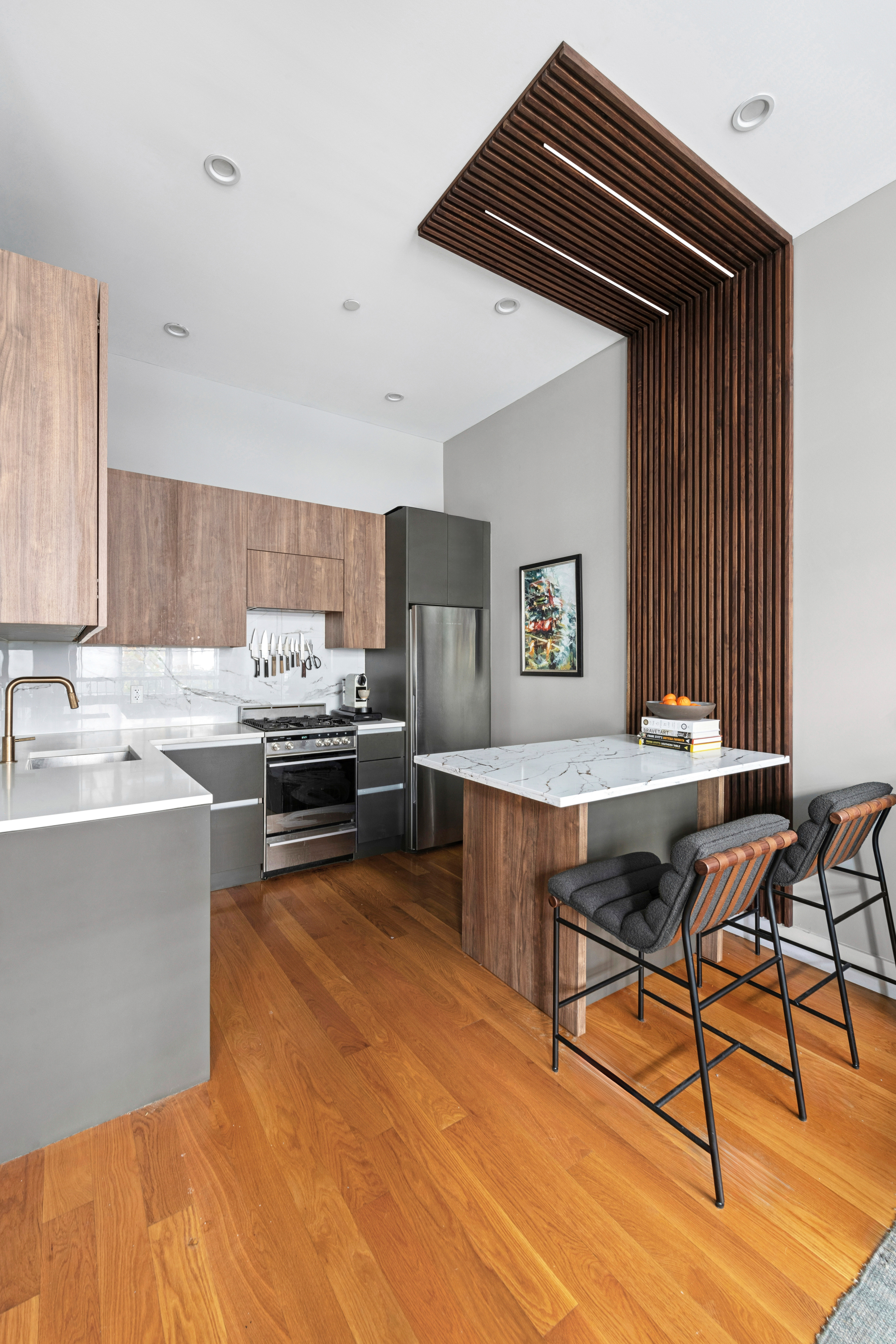222 Withers Street, Unit 1A Brooklyn, NY 11211 - Photo 4 of 15 a living room with stainless steel appliances kitchen island a table chairs in it and a window