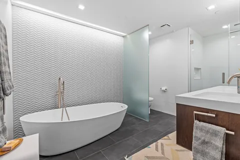 a bathroom with a toilet sink and a mirror