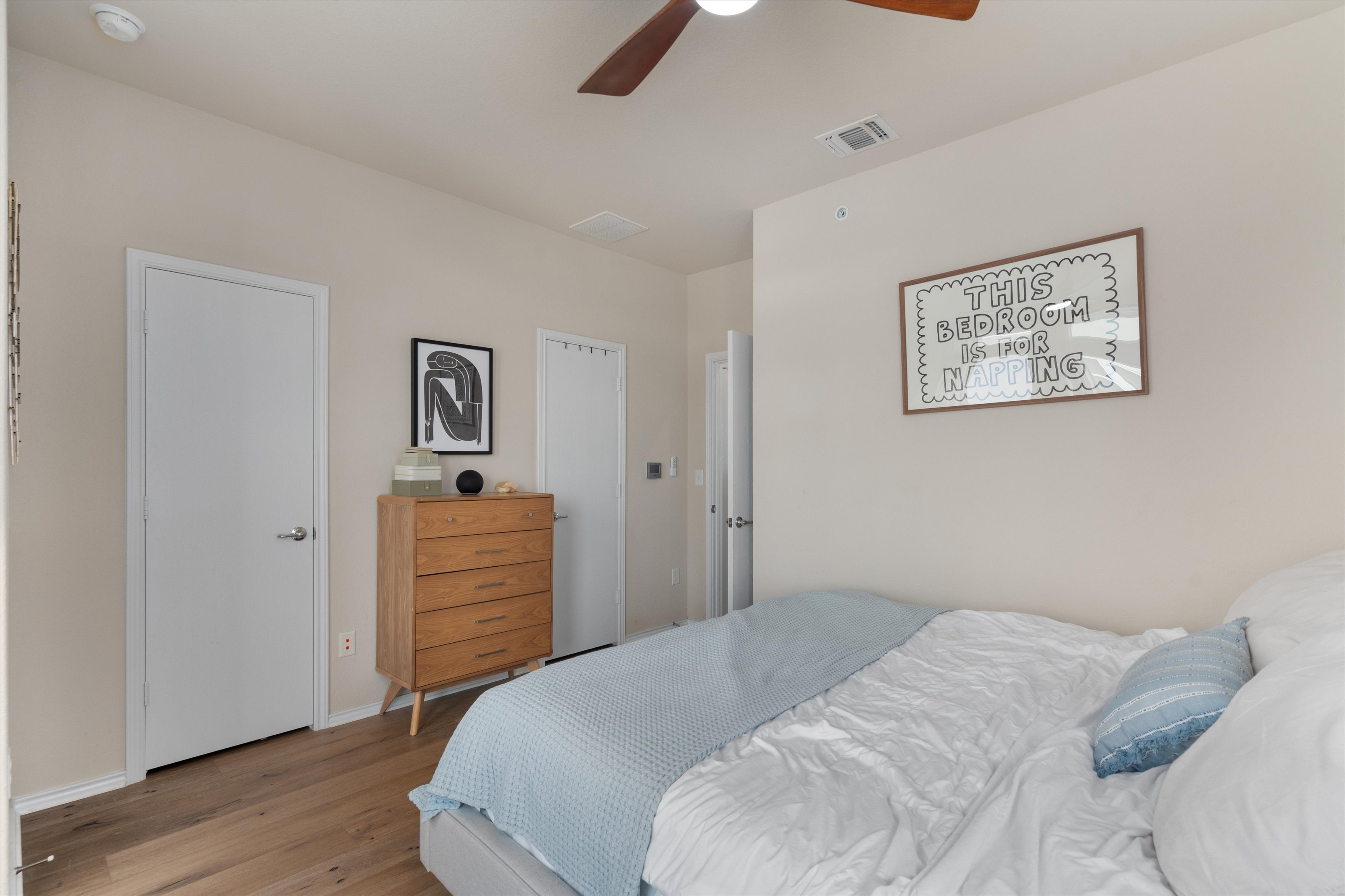 4330 Olenick Street Austin, TX 78723 - Photo 27 of 29 a bedroom with a bed and wooden floor