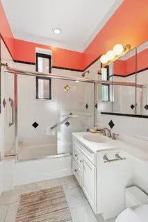 a bathroom with a sink a toilet and shower