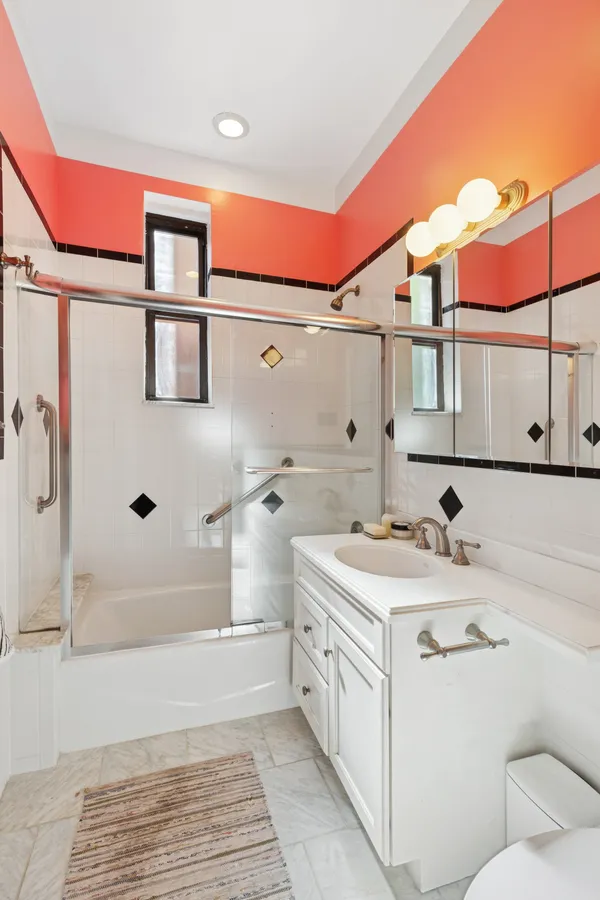 a bathroom with a sink a toilet and shower