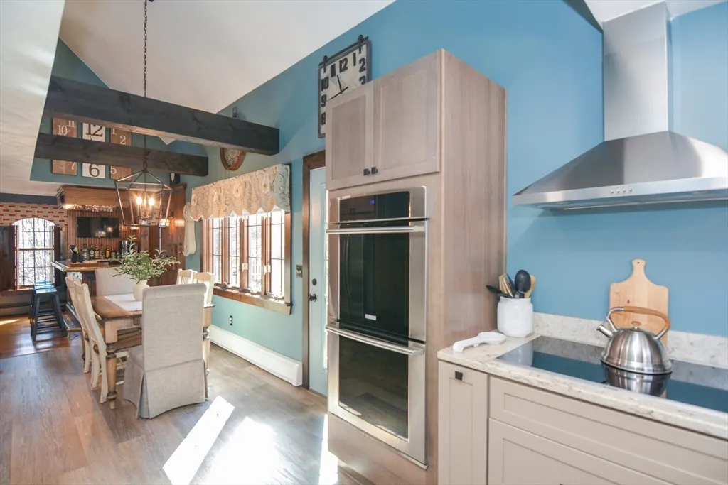 a kitchen with stainless steel appliances granite countertop a refrigerator and a stove top oven