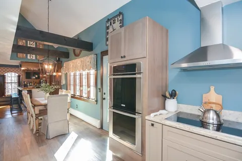 a kitchen with stainless steel appliances granite countertop a refrigerator and a stove top oven